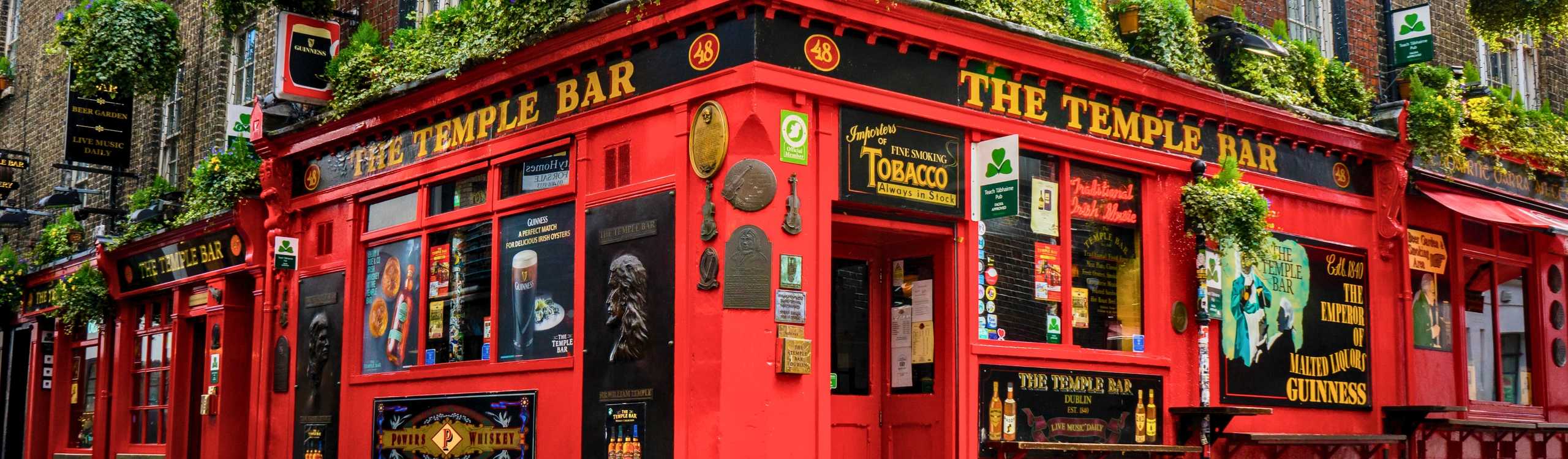 Maximize your Ireland vacation itinerary – Compare and book the all-inclusive Dublin Pass online for 2026 The iconic bright red exterior of The Temple Bar pub on a cobblestone street, a top thing to do with the Dublin City Pass in 2026